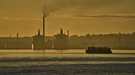 A ferry crosses Havana Bay past the Nico Lopez oil refinery where Cuban tankers are anchored in Havana Bay, 24 March 2026
