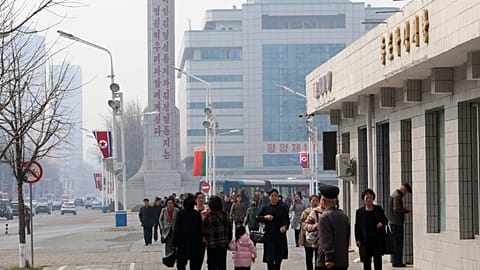 People walk in the street of the Central District in Pyongyang, Wednesday, March 25, 2026. 