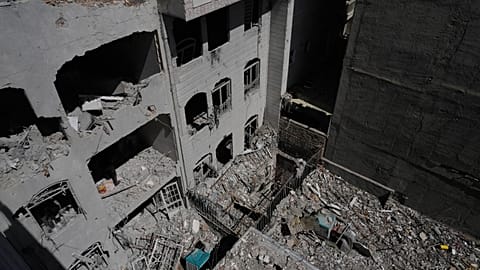 A building is damaged after a nearby residential building was hit in an overnight US-Israeli strike in Tehran, Friday, March 27, 2026. 