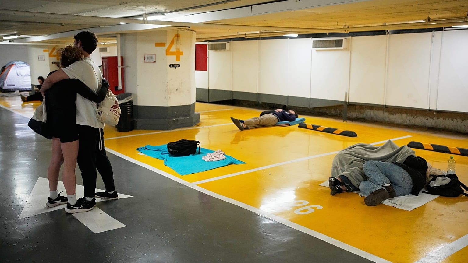 صورة تعبيرية- يلجأ الناس إلى مرآب سيارات تحت الأرض بينما تدق صفارات الإنذار من غارات جوية تحذر من هجوم صاروخي قادم من إيران