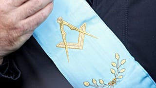 FILE: A French Freemason, wearing his lodge's scarf, looks on during a gathering of members of Masonic bodies near the French parliament in Paris, 10 December 2005