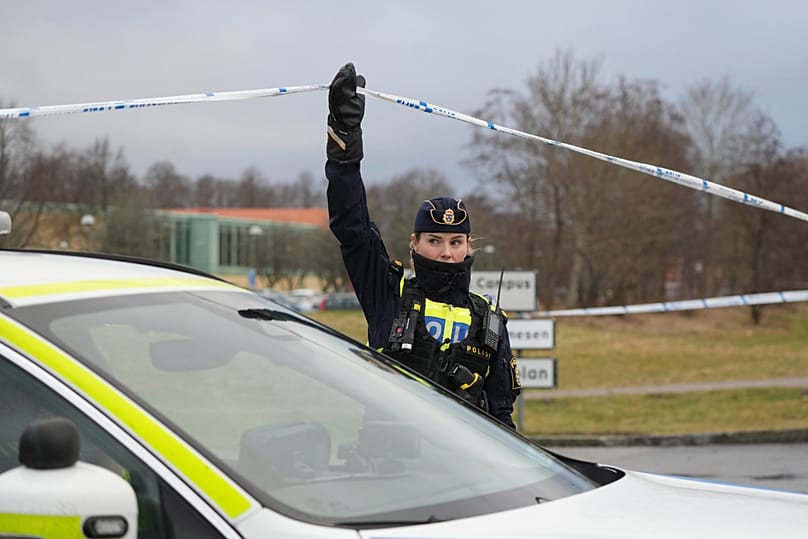 A police officer helps a police car out of an area cordoned off on the outskirts of Orebro, 5 February, 2025