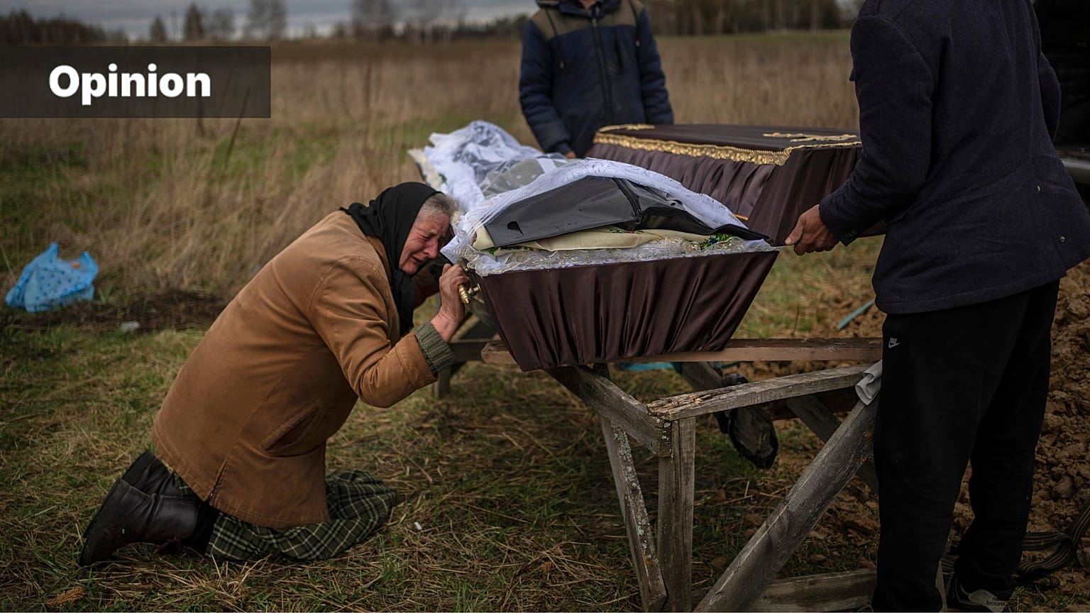 FILE - Nadiya Trubchaninova, 70, cries while holding the coffin of her son Vadym, 48, in the cemetery of Mykulychi, Ukraine, April 16, 2022