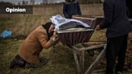 FILE - Nadiya Trubchaninova, 70, cries while holding the coffin of her son Vadym, 48, in the cemetery of Mykulychi, Ukraine, April 16, 2022