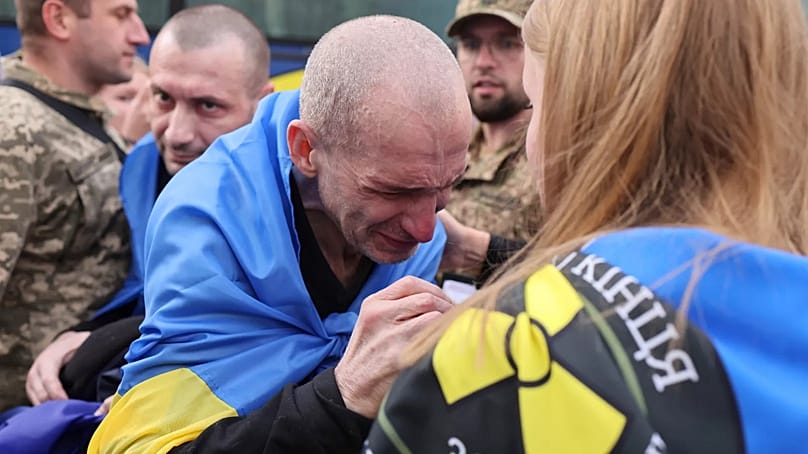 A Ukrainian soldier cries after returning from captivity following a POWs exchange between Russia and Ukraine, in Chernyhiv region, Ukraine, Sunday, Aug. 24, 2025
