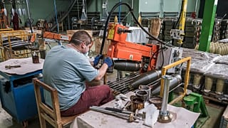 A worker at VMZ Sopot preparing the forged steel artillery shell bodies in the mechanical workshop, 17 October, 2025