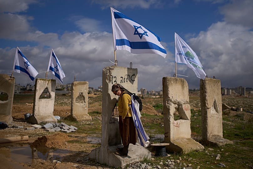 A woman attends the inauguration ceremony of a newly-legalized Jewish settlement, Yatziv, adjacent to the Palestinian town of Beit Sahour, in the West Bank, Jan. 19, 2026.