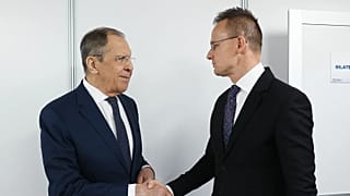  Russian Foreign Minister Sergey Lavrov, left, shakes hands with Hungarian Minister of Foreign Affairs and Trade Peter Szijjarto on the sidelines of the OSCE