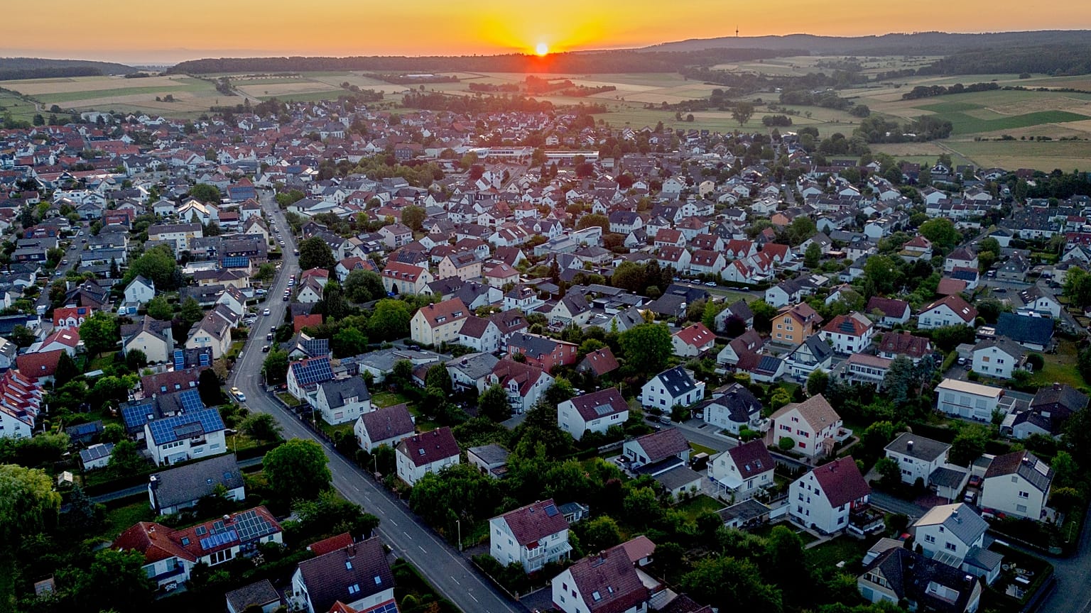 FILE: The sun rises over the city of Wehrheim near Frankfurt, Germany, Thursday, July 6, 2023.