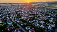 FILE: The sun rises over the city of Wehrheim near Frankfurt, Germany, Thursday, July 6, 2023.
