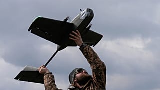 FILE - A student soldier of the Yatagan School for Unmanned Aerial Systems launches a training target drone during drills in the Kyiv region, Ukraine. 20 March, 2026