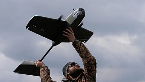 FILE - A student soldier of the Yatagan School for Unmanned Aerial Systems launches a training target drone during drills in the Kyiv region, Ukraine. 20 March, 2026