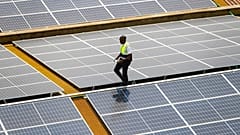 Mark Munyua, CP solar's technician, examines solar panels on the roof of a company in Nairobi, Kenya, Friday, Sept. 1, 2023