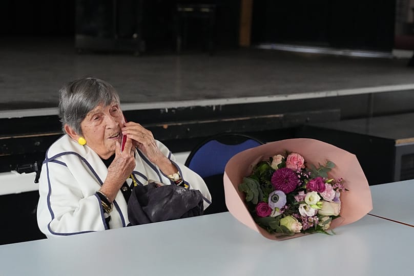 Ginette Kolinka makes a phone call after she met some pupils in a Paris-region high school in Saint-Maur-des-Fosses, 21 March, 2026