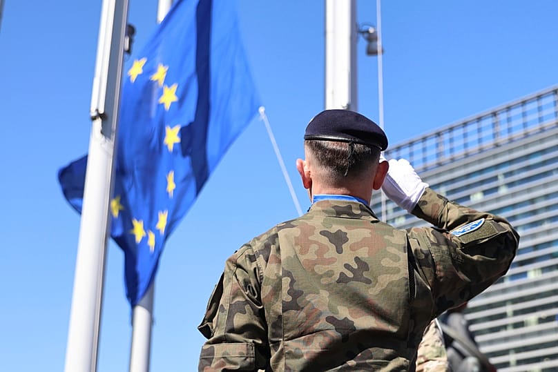 FILE - A Eurocorps soldier salutes the European flag on the 80th anniversary of the end of WWII in Europe, 7 May 2025, at the European Parliament in Strasbourg, France