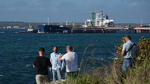 Journalists do a standup in front of the Russian-flagged oil tanker Anatoly Kolodkin docked in Matanzas, 31 March, 2026