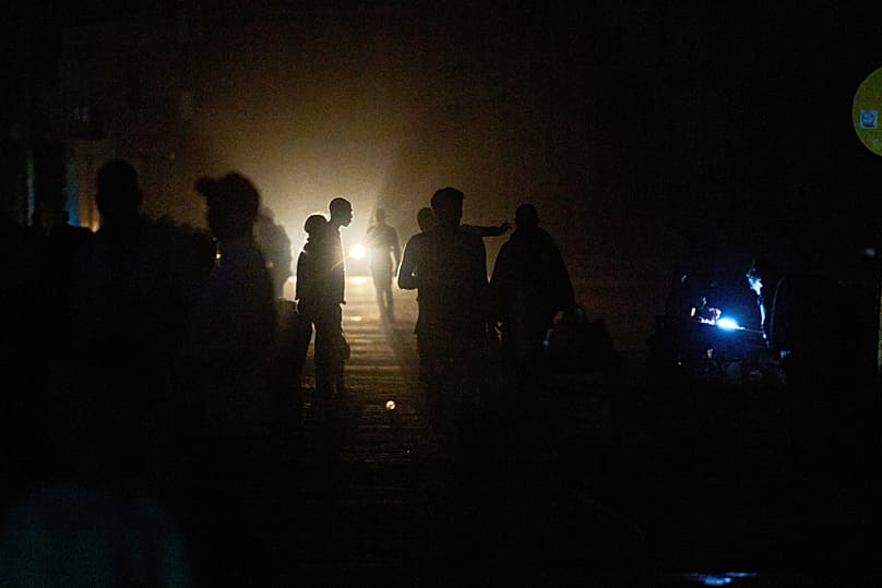 People walk on a street in the dark during a blackout in Havana, 21 March, 2026