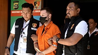 Steven Lyons, described as a senior figure in an international crime syndicate, is escorted by police officers at the regional police headquarters in Denpasar, 31 March, 2026