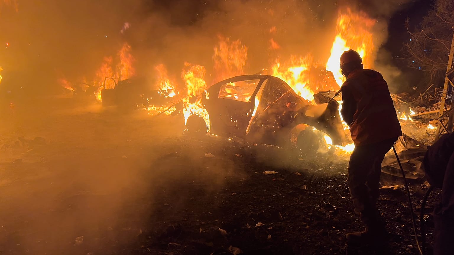 A firefighter extinguishes a car at the site of Israeli airstrikes, in Beirut, Lebanon, Wednesday, April 1, 2026.