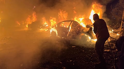 A firefighter extinguishes a car at the site of Israeli airstrikes, in Beirut, Lebanon, Wednesday, April 1, 2026.