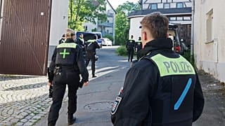 FILE: Police officers search buildings following the ban of the Reichsbürger group "Kingdom of Germany" in Gera, 13 May 2025