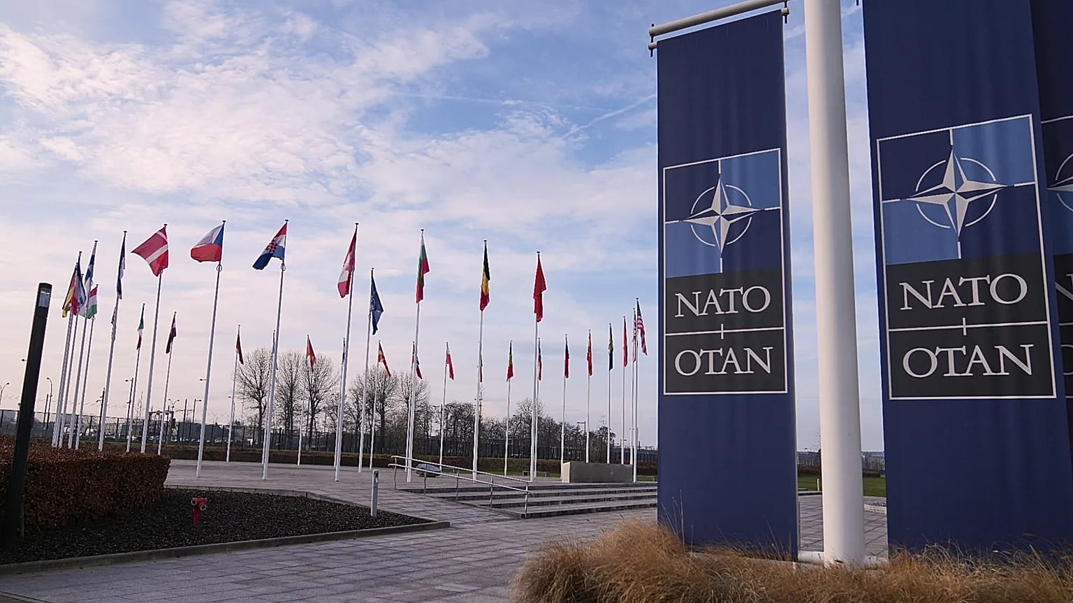 Flags flap in the wind outside NATO headquarters in Brussels, 19 January, 2026