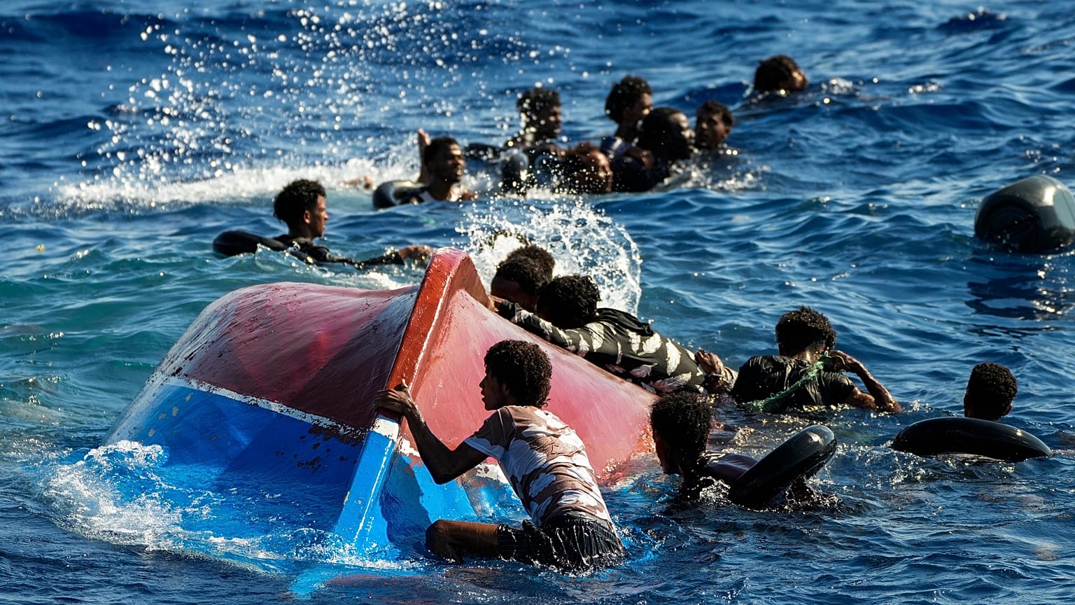  Migrants from Syria and Libya in a wooden boat call for help as they are assisted by Spanish NGO Open Arms Thursday, Aug. 11, 2022