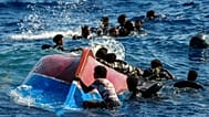  Migrants from Syria and Libya in a wooden boat call for help as they are assisted by Spanish NGO Open Arms Thursday, Aug. 11, 2022