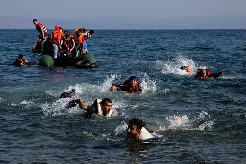 Migrants whose boat stalled while crossing from Turkey to Greece swim to the island of Lesbos, 20 September, 2015