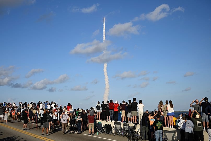 Spectators look on from the A. Max Brewer Bridge as NASA's Artemis II moon rocket lifts off Wednesday, April 1, 2026, as seen from Titusville, Fla. 