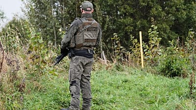 An Estonian border guard patrols the Russian border near Vinski, Estonia, Monday, Sept. 15, 2025.