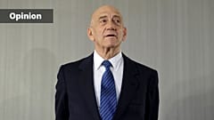 FILE - Former Israeli Prime Minister Ehud Olmert takes questions from reporters after a news conference in New York, Tuesday, Feb. 11, 2020.