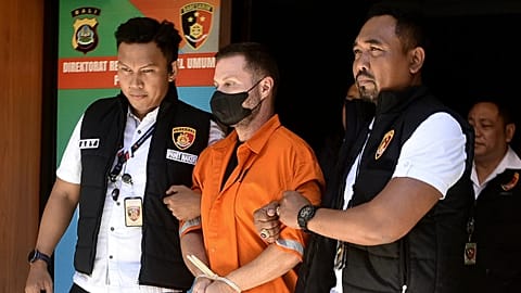 Steven Lyons, described as a senior figure in an international crime syndicate, is escorted by police officers at the regional police headquarters in Denpasar, 31 March, 2026