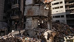 A man stands at the site of a building destroyed in an Israeli air strike in central Beirut, 12 April, 2026