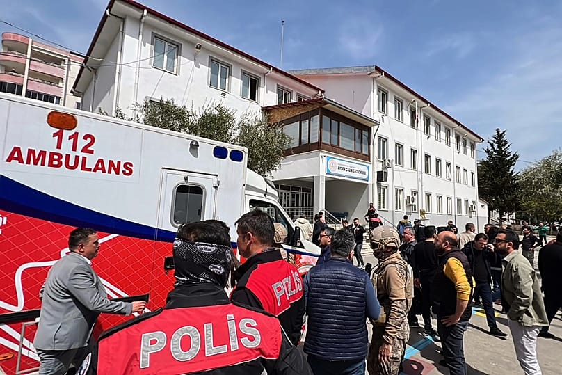 People stand at the courtyard of a secondary school where an assailant opened fire in Kahramanmaraş, 15 April, 2026