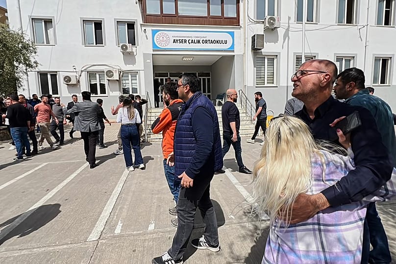 People stand at the courtyard of a secondary school where an assailant opened fire in Kahramanmaraş, 15 April, 2026