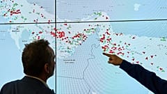 Hapag-Lloyd employees monitor the status of cargo ships in the Strait of Hormuz on a screen in Hamburg, 15 April, 2026