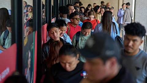 Immigrants queue to request public transport certificate in Madrid, 16 April, 2026