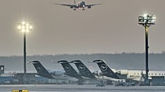 A plane comes in for landing as Lufthansa aircraft are parked at the airport due to a two-day strike by Lufthansa pilots, in Frankfurt, Germany, Thursday, March 12, 2026.