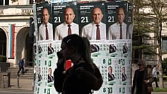 People pass posters of former president Rumen Radev after Bulgaria's parliamentary election in Sofia, 20 April, 2026