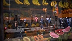 Migrants queue outside Barcelona City Hall to obtain paperwork needed to apply for Spain's immigration amnesty, 20 April, 2026