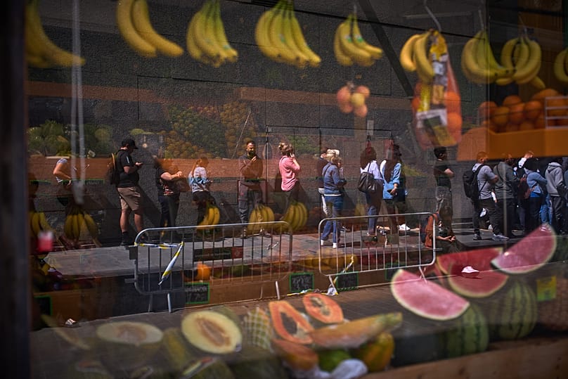 Migrants queue outside Barcelona City Hall to obtain paperwork needed to apply for Spain's immigration amnesty, 20 April, 2026