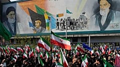 Gyászolók iráni zászlókat visznek egy gyászmenetben Teheránban, 2026. április 1-jén