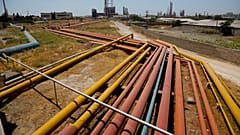 FILE - Oil pipes run to the the Baku oil refinery named after Heydar Aliyev in Baku, Azerbaijan, Friday, June 12, 2015.