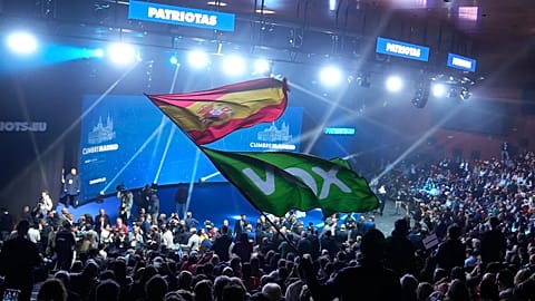 A Spanish flag and a Spanish far-right VOX party flag are waved during the far-right Patriots for Europe summit in Madrid, 8 February, 2025
