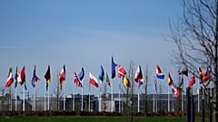 FILE: Flags of NATO member countries flap in the wind outside at NATO headquarters in Brussels, 14 March 2024