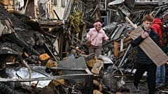 سكان محليون يسيرون في ساحة حي سكني تعرض لأضرار بالغة بعد غارة روسية على أوديسا، أوكرانيا، الجمعة 24 أبريل 2026. 