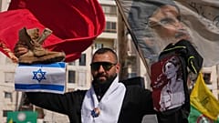 Мужчина с портретом ливанской журналистки Амаль Халиль, погибшей от израильского авиаудара, во время акции в Дахие на юге Бейрута, 25 апреля 2026 г.(AP/Хассан Аммар)