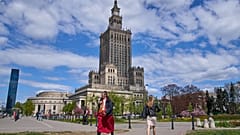 Fußgänger gehen in Warschau an dem Palast der Kultur und Wissenschaft vorbei.