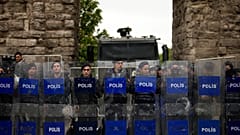 Riot police officers stand guard blocking the route to protesters as Union members march during Labour Day celebrations in Istanbul, 1 May, 2024
